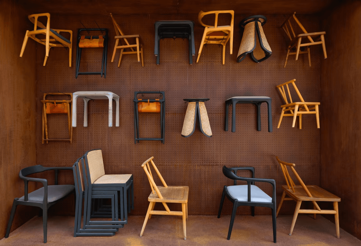 A wall display of mid-century modern wooden chairs