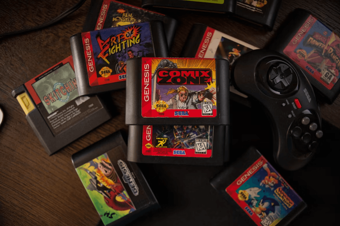 A pile of retro Sega Genesis game cartridges and a controller