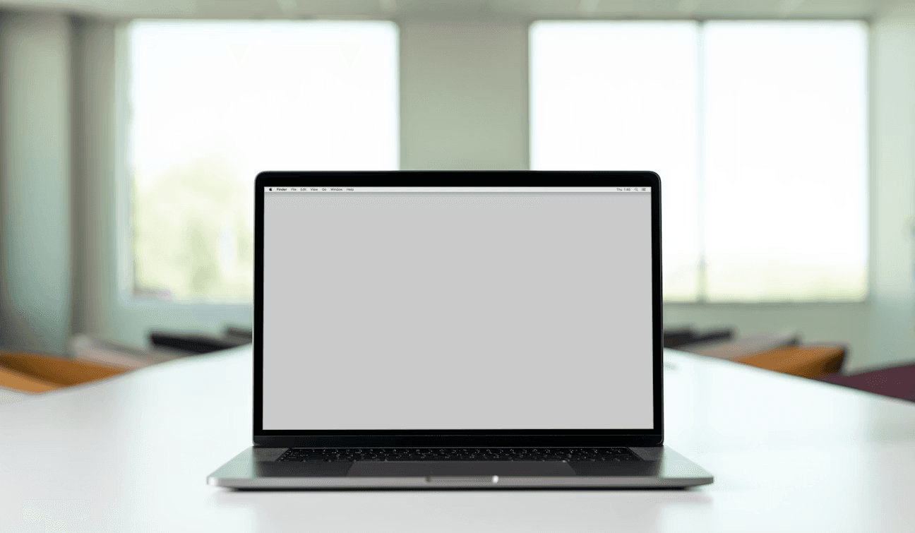 A laptop open on a white table